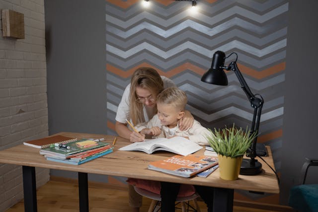 Mother teaching her son about his assignment
