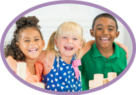 A diverse group of children from different racial backgrounds laughing and playing together, sharing a joyful and happy moment.